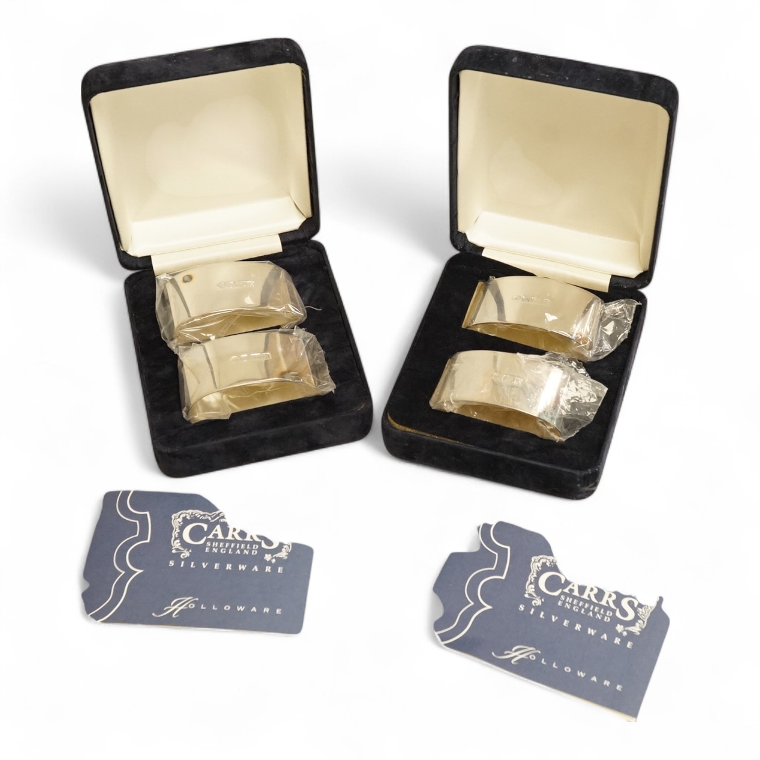 Two boxed pairs of Elizabeth II silver napkin rings by Carr's of Sheffield, Sheffield, 1997.